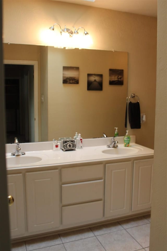 full bath featuring tile patterned floors, double vanity, and a sink