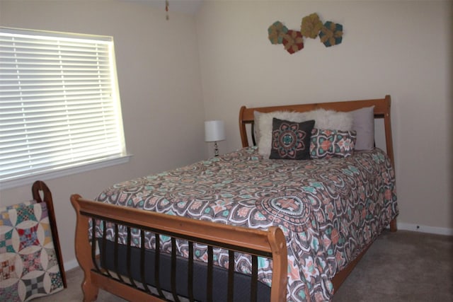 carpeted bedroom featuring baseboards