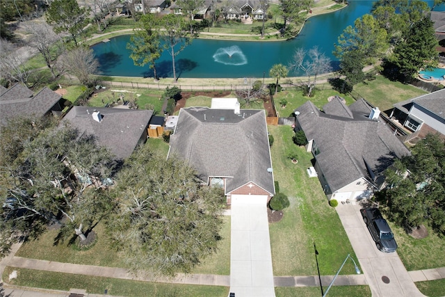 drone / aerial view featuring a residential view and a water view