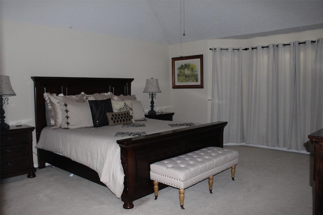 carpeted bedroom with vaulted ceiling