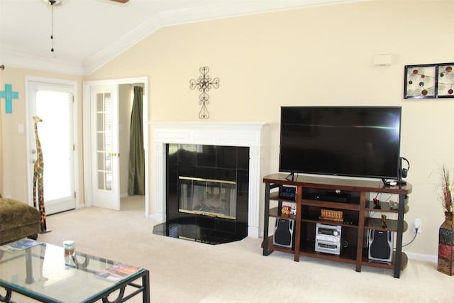 living area featuring carpet flooring, a fireplace, crown molding, and vaulted ceiling