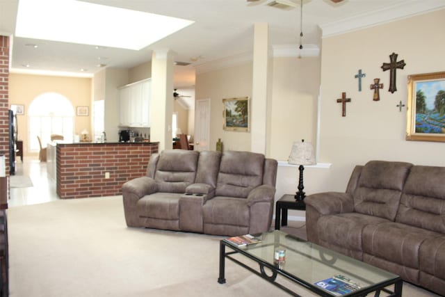 carpeted living area with ceiling fan and ornamental molding