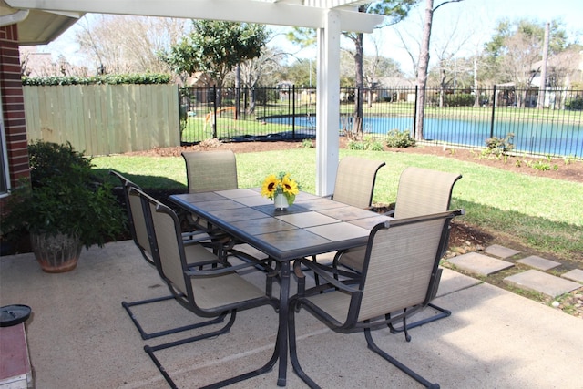 view of patio with outdoor dining area and fence