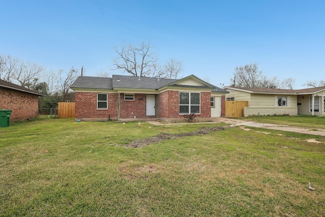 ranch-style home with a gate, brick siding, fence, and a front lawn