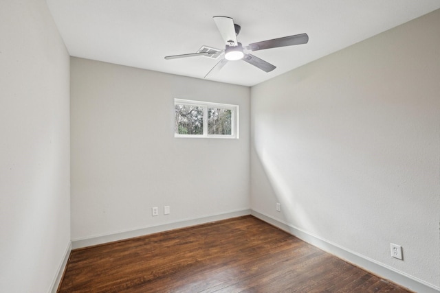 empty room featuring ceiling fan, wood finished floors, and baseboards