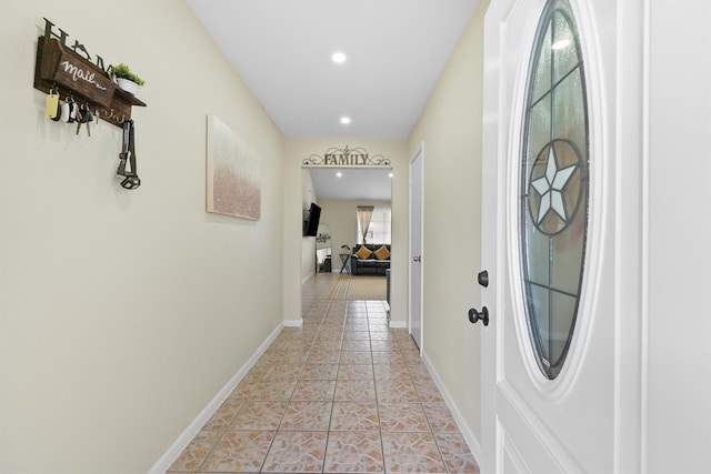 hallway featuring recessed lighting, baseboards, and light tile patterned floors