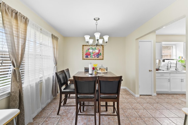 dining room featuring a notable chandelier, baseboards, and light tile patterned floors