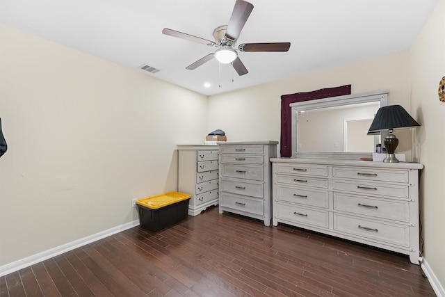 bedroom featuring a ceiling fan, visible vents, dark wood finished floors, and baseboards