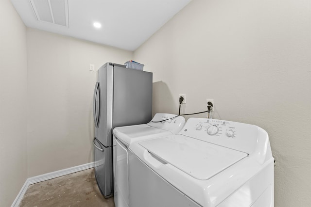 laundry room with laundry area, baseboards, visible vents, and washing machine and clothes dryer