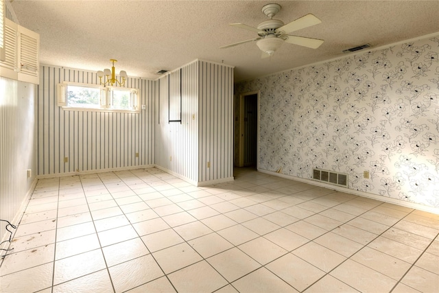 spare room with visible vents, a textured ceiling, and wallpapered walls