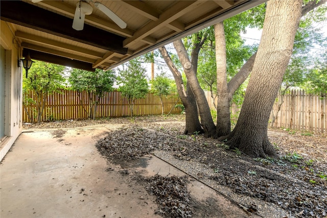 view of yard featuring a ceiling fan, a patio area, and fence