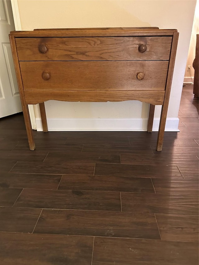 room details featuring baseboards and wood finished floors