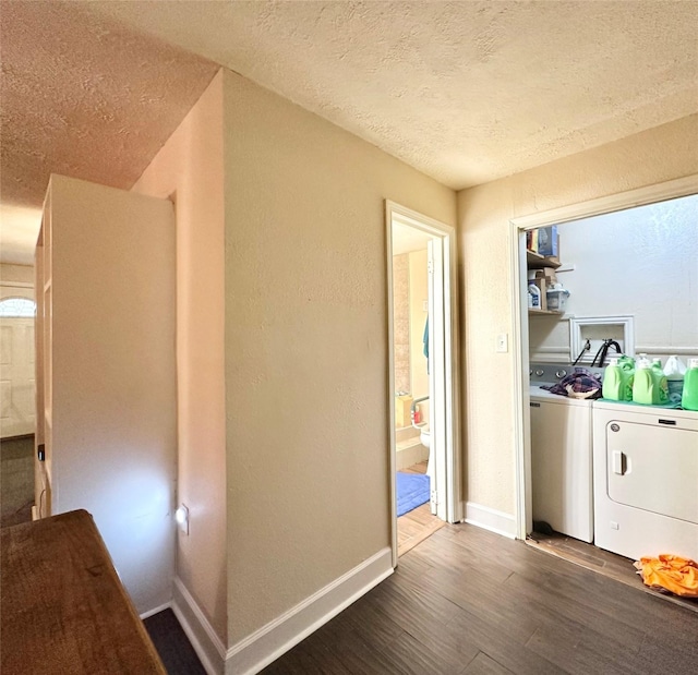 interior space with washer and clothes dryer, a textured ceiling, wood finished floors, laundry area, and baseboards