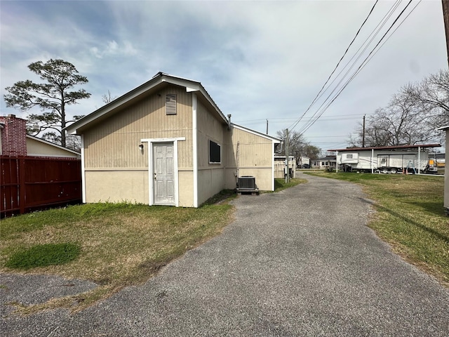 exterior space with central AC unit and fence