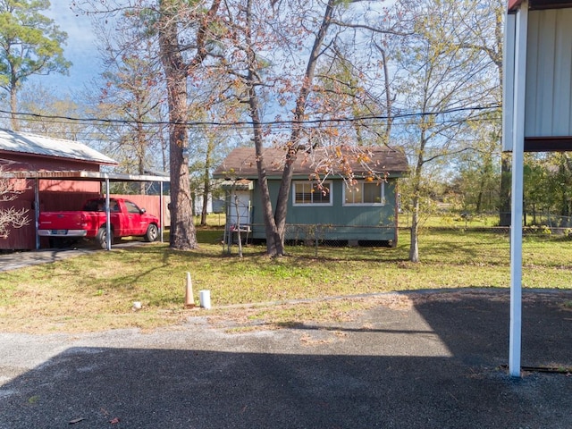 view of front facade with a carport and a front yard