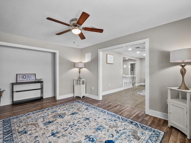 living area featuring a ceiling fan, recessed lighting, wood finished floors, and baseboards