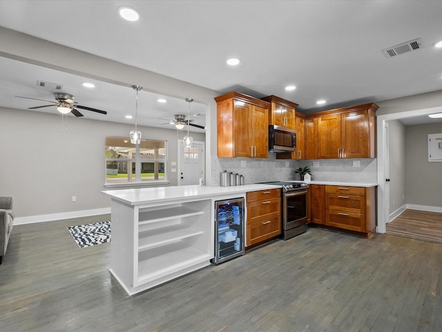 kitchen with light countertops, beverage cooler, visible vents, and stainless steel appliances