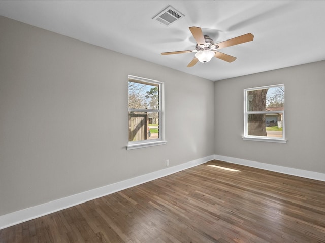 unfurnished room with visible vents, ceiling fan, baseboards, and wood finished floors