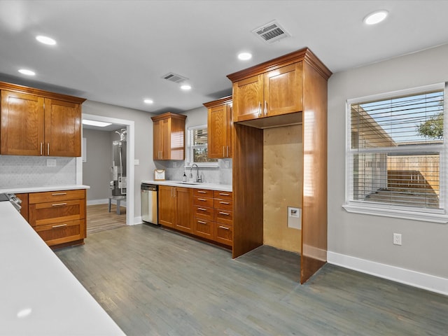 kitchen with visible vents, light countertops, dark wood-type flooring, and stainless steel dishwasher