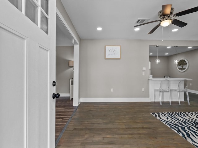 interior space featuring visible vents, a ceiling fan, dark wood finished floors, recessed lighting, and baseboards