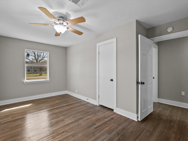 unfurnished bedroom featuring visible vents, ceiling fan, baseboards, and wood finished floors