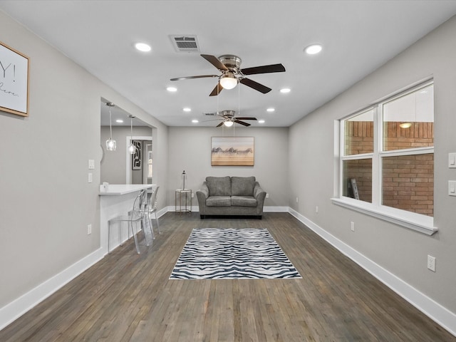 unfurnished room with dark wood finished floors, visible vents, and baseboards