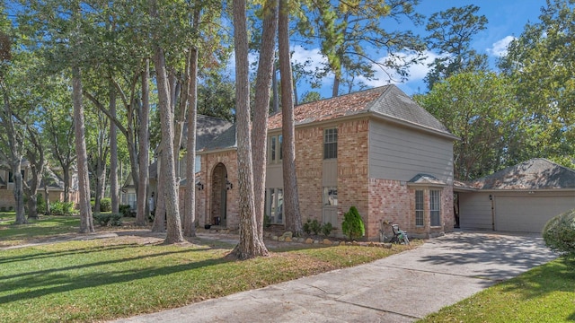 view of front of property featuring an attached garage, concrete driveway, brick siding, and a front yard