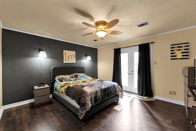 bedroom with crown molding, wood finished floors, visible vents, and access to exterior