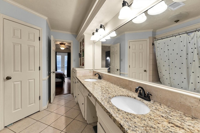 bathroom with french doors, ornamental molding, and a sink