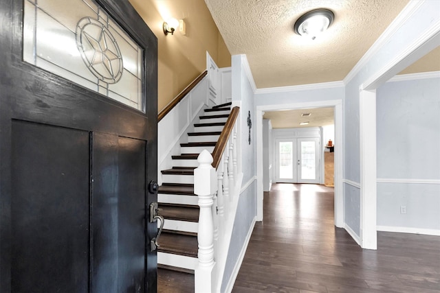 entrance foyer featuring a textured ceiling, wood finished floors, french doors, stairway, and crown molding