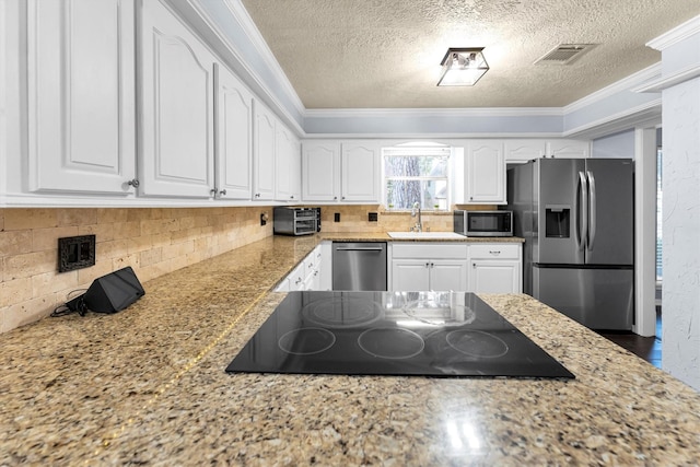 kitchen featuring visible vents, appliances with stainless steel finishes, and crown molding