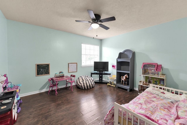 bedroom featuring a textured ceiling, wood finished floors, a ceiling fan, and baseboards