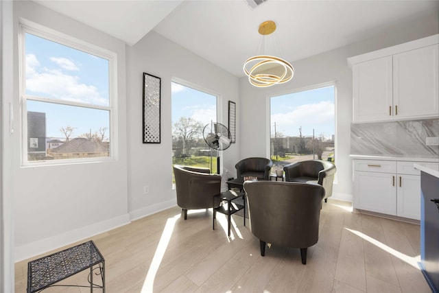 dining room with light wood-style flooring and baseboards