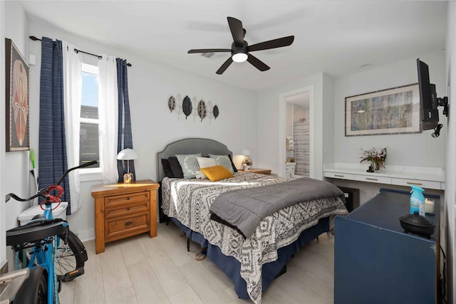 bedroom with a ceiling fan, light wood-type flooring, and connected bathroom