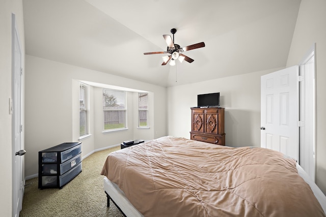 bedroom featuring a ceiling fan, carpet flooring, vaulted ceiling, and baseboards