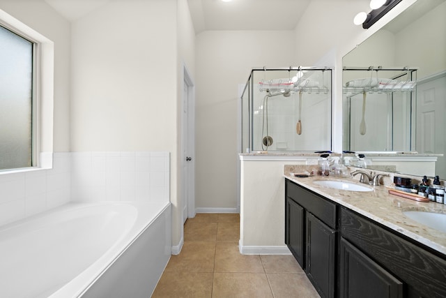 full bathroom featuring a garden tub, a sink, a shower stall, tile patterned floors, and double vanity