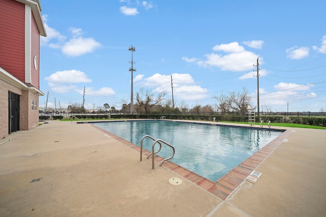 community pool featuring a patio area and fence