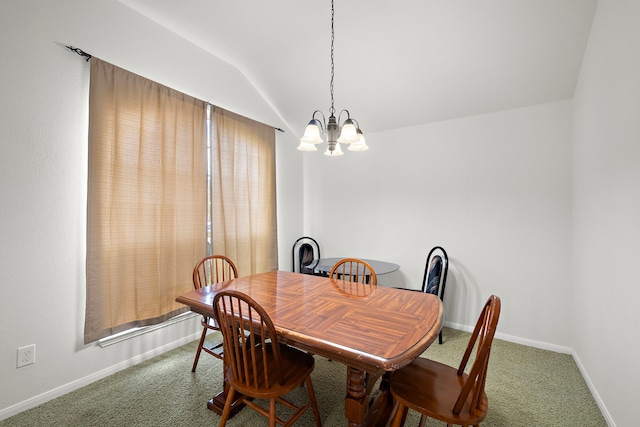 carpeted dining area featuring a notable chandelier, vaulted ceiling, and baseboards