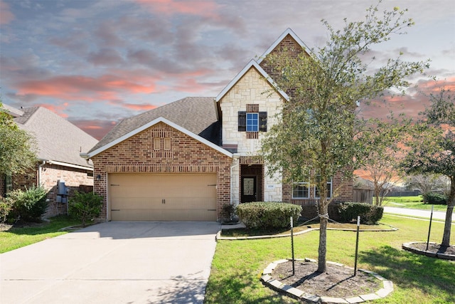 view of front of home with a garage, a lawn, stone siding, roof with shingles, and brick siding