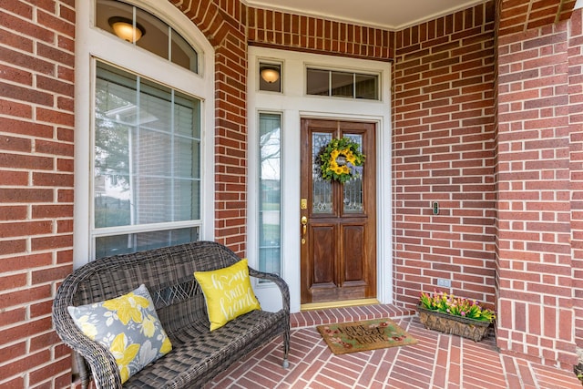 doorway to property featuring brick siding