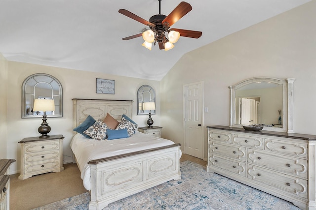 bedroom with light colored carpet, vaulted ceiling, and ceiling fan