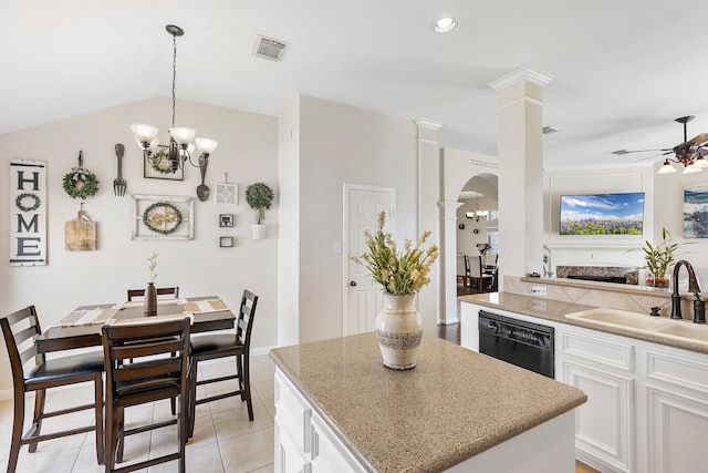 kitchen featuring arched walkways, visible vents, a sink, dishwasher, and ornate columns