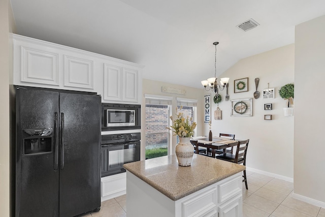 kitchen with black appliances, vaulted ceiling, light tile patterned floors, and white cabinets