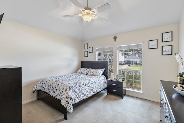 bedroom with baseboards, a ceiling fan, and light colored carpet