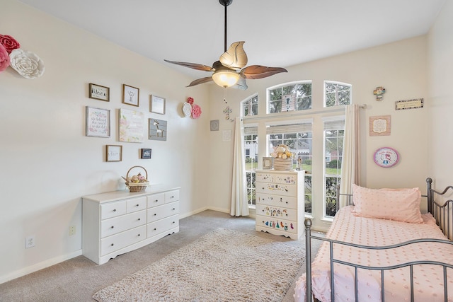 bedroom featuring a ceiling fan, light carpet, and baseboards