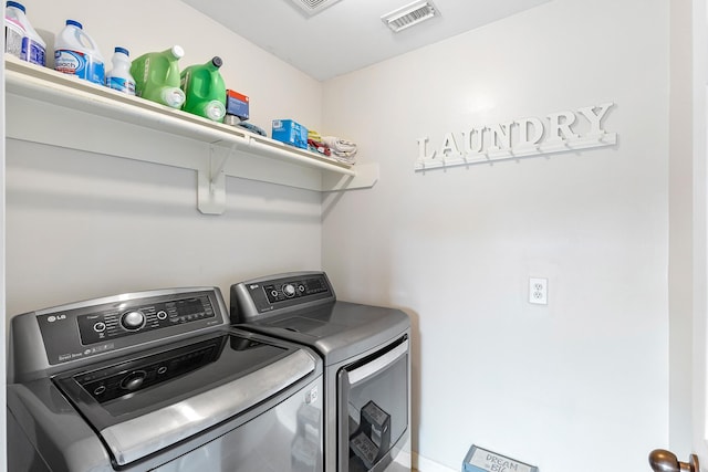 laundry area with washer and dryer, laundry area, and visible vents