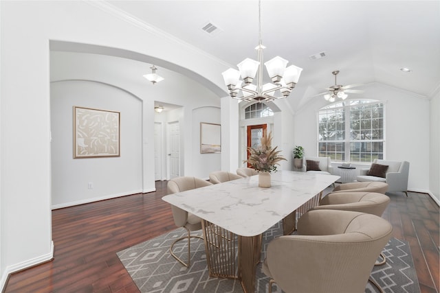 dining area with arched walkways, dark wood-style flooring, lofted ceiling, visible vents, and ornamental molding