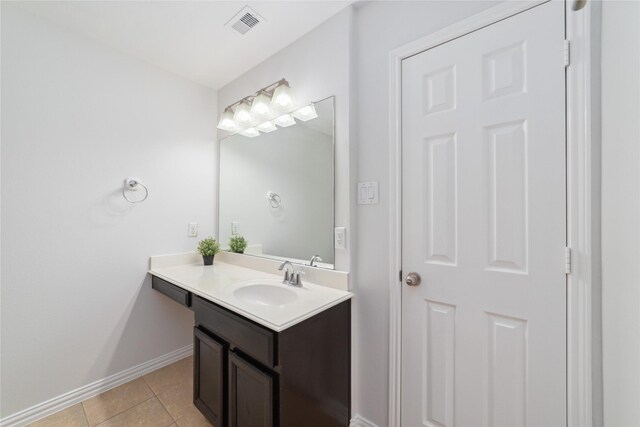 bathroom featuring tile patterned floors, baseboards, visible vents, and vanity