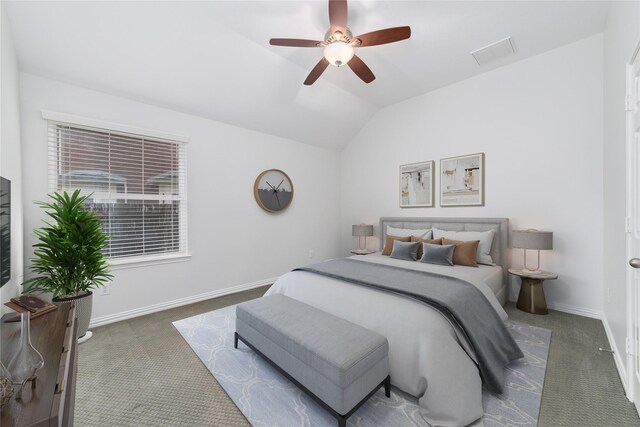 carpeted bedroom featuring lofted ceiling, baseboards, visible vents, and a ceiling fan