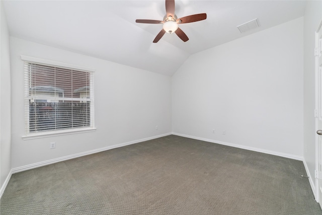 unfurnished room featuring visible vents, a ceiling fan, carpet flooring, vaulted ceiling, and baseboards